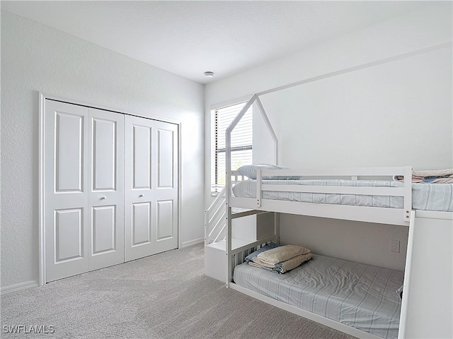 carpeted bedroom with a closet