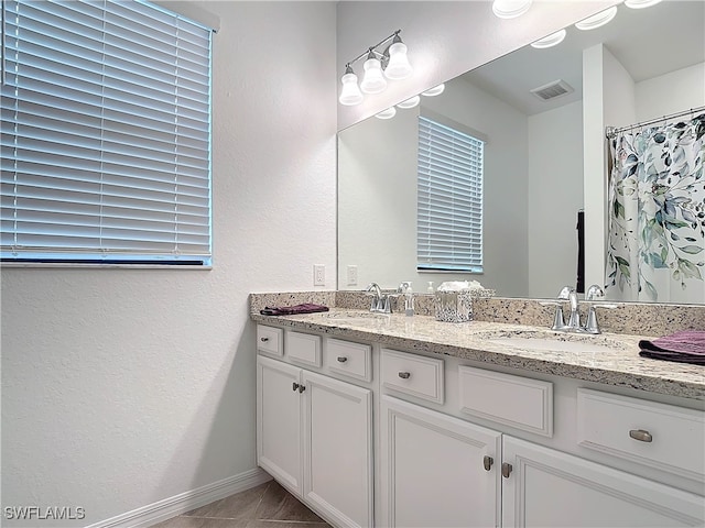 bathroom featuring tile patterned flooring, vanity, and a shower with shower curtain