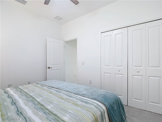 carpeted bedroom featuring ceiling fan and a closet