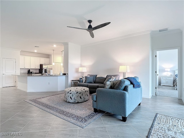 tiled living room featuring crown molding and ceiling fan