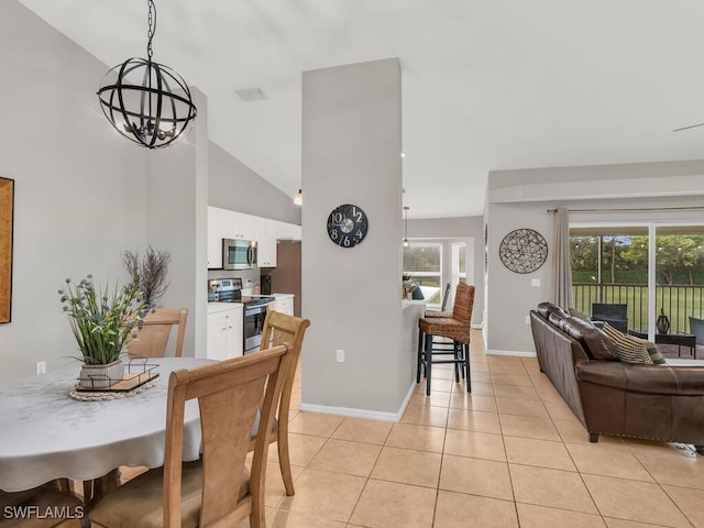 dining room featuring light tile patterned floors, high vaulted ceiling, and a notable chandelier