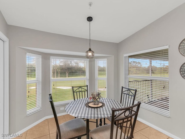 dining space with lofted ceiling and light tile patterned flooring