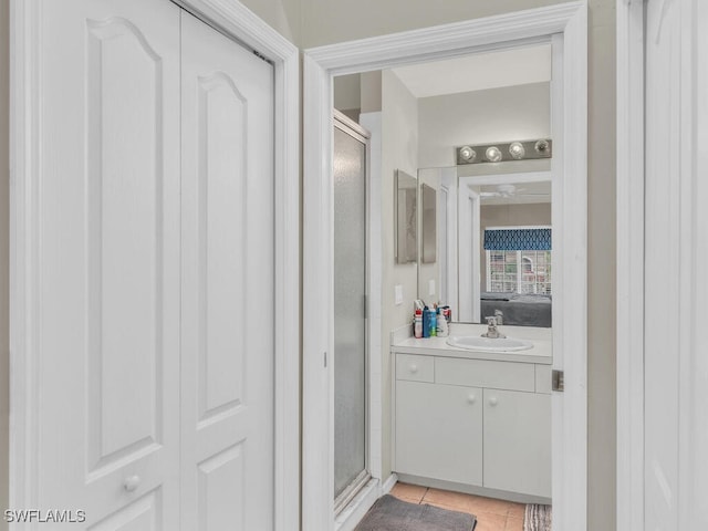 bathroom with tile patterned floors, vanity, and walk in shower