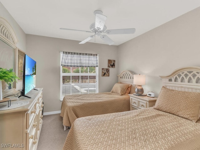 bedroom with ceiling fan and light carpet