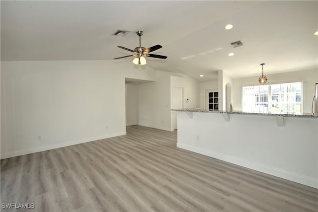 unfurnished living room featuring ceiling fan, light hardwood / wood-style floors, and lofted ceiling