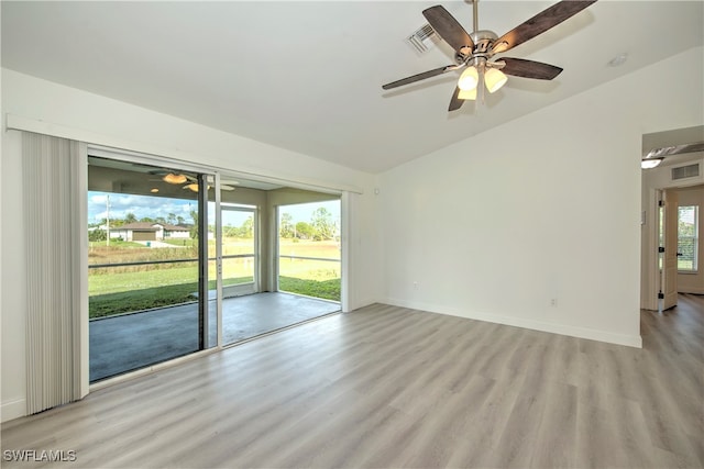 unfurnished room featuring ceiling fan, light wood-type flooring, and vaulted ceiling