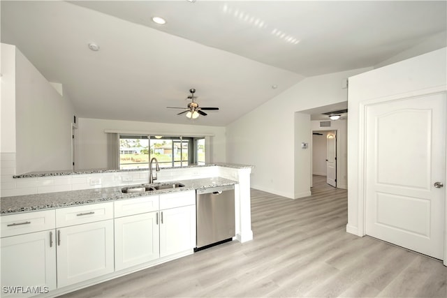 kitchen with stainless steel dishwasher, vaulted ceiling, ceiling fan, sink, and white cabinets