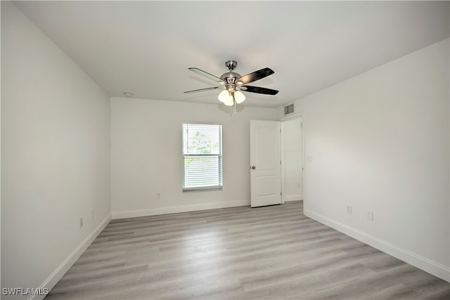 spare room featuring light wood-type flooring and ceiling fan