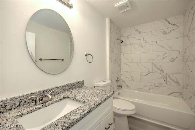 full bathroom featuring vanity, toilet, wood-type flooring, and tiled shower / bath