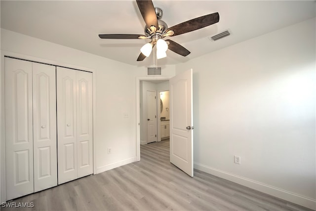 unfurnished bedroom featuring a closet, light hardwood / wood-style floors, and ceiling fan