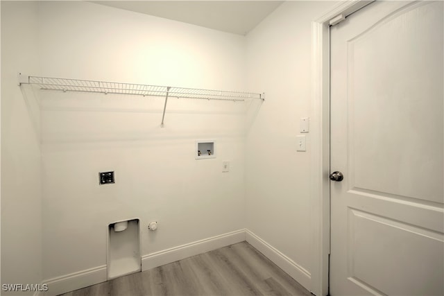 laundry room with hookup for an electric dryer, washer hookup, light wood-type flooring, and hookup for a gas dryer