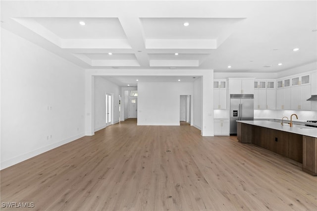 kitchen featuring coffered ceiling, built in refrigerator, dark brown cabinets, white cabinets, and light wood-type flooring