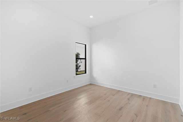 spare room with light hardwood / wood-style flooring