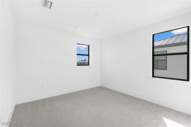 unfurnished room with light colored carpet