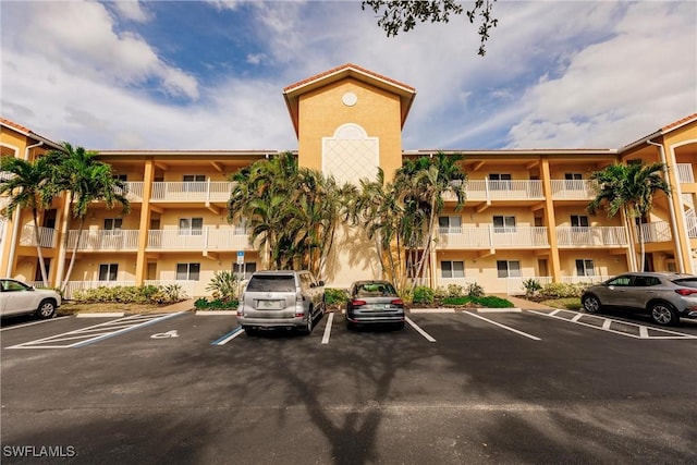 view of building exterior with uncovered parking