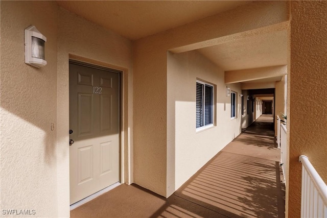 doorway to property with stucco siding