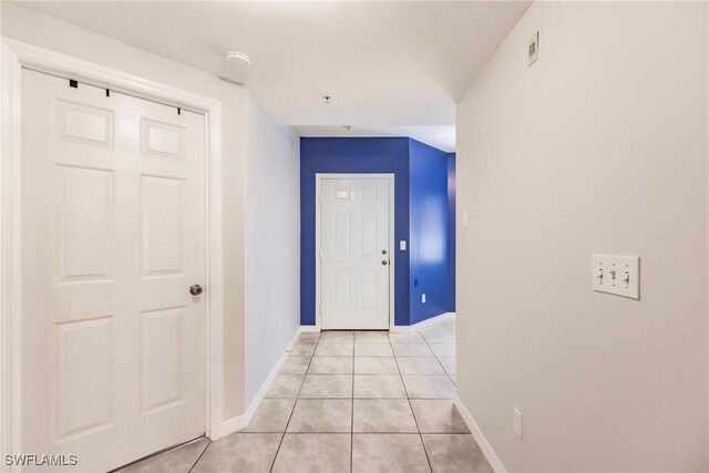 corridor with light tile patterned flooring