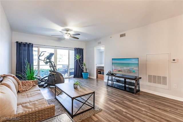 living room with ceiling fan and wood-type flooring