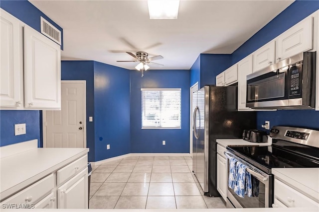 kitchen with light tile patterned floors, ceiling fan, appliances with stainless steel finishes, light countertops, and white cabinetry