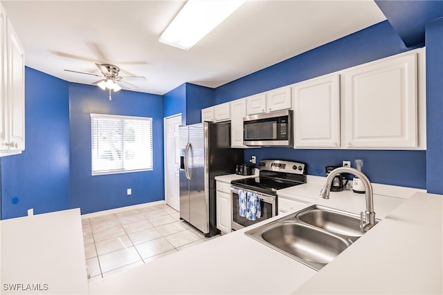 kitchen with white cabinets, sink, ceiling fan, light tile patterned floors, and appliances with stainless steel finishes