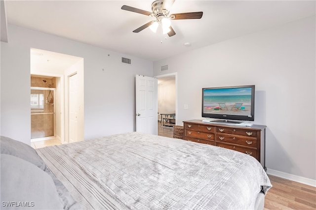 bedroom with ensuite bathroom, light hardwood / wood-style flooring, and ceiling fan