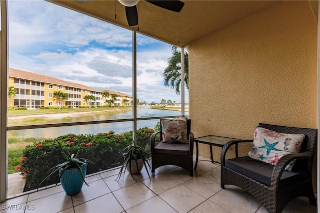 balcony featuring a water view and ceiling fan