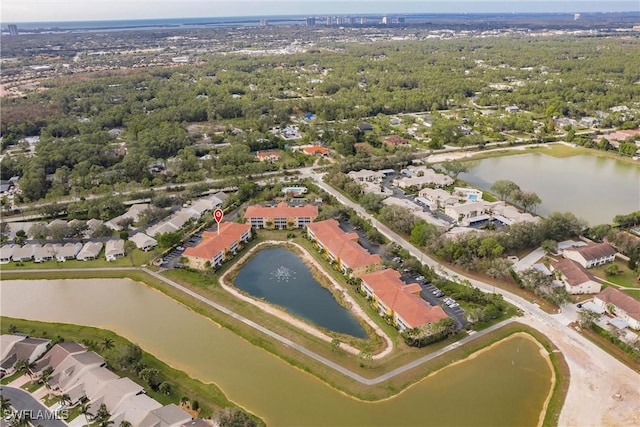 drone / aerial view featuring a residential view and a water view