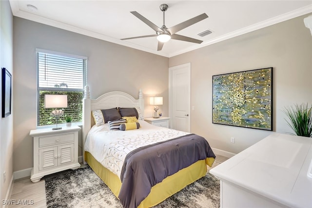 bedroom with ornamental molding, ceiling fan, and wood-type flooring