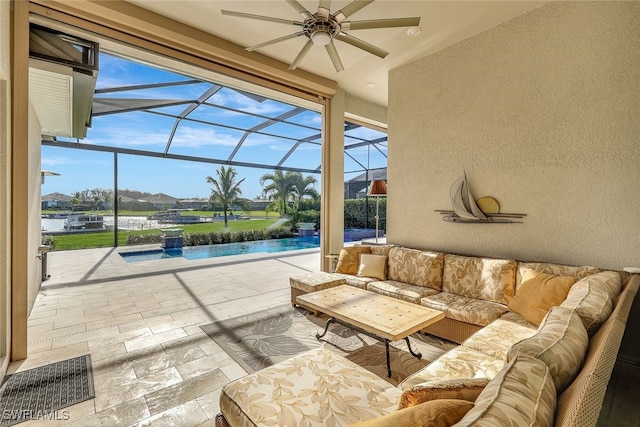 view of patio with outdoor lounge area, a water view, glass enclosure, and ceiling fan