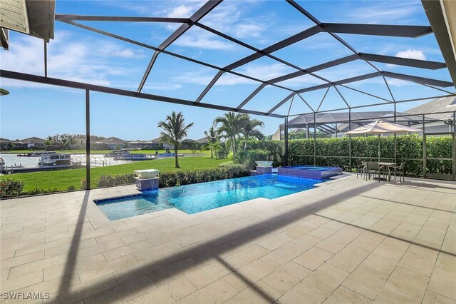 view of pool with an in ground hot tub, pool water feature, glass enclosure, a patio, and a lawn