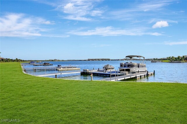 view of dock featuring a lawn and a water view