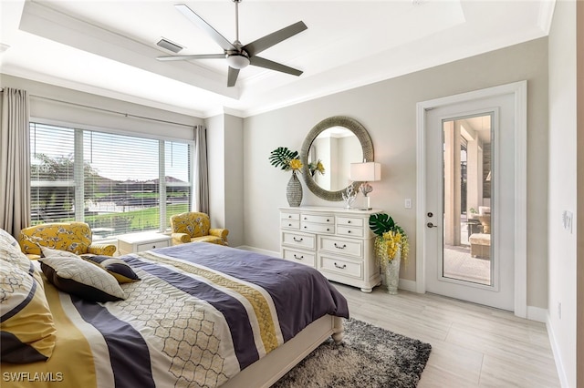 bedroom featuring a raised ceiling, ceiling fan, and crown molding