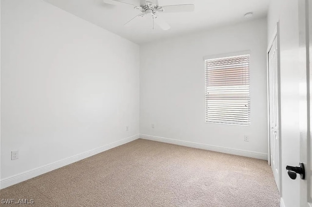 empty room featuring carpet floors and ceiling fan