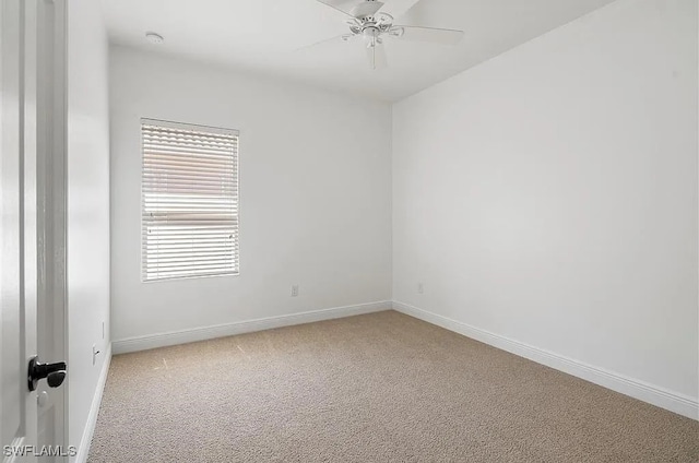 carpeted empty room featuring ceiling fan