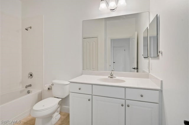 full bathroom featuring tiled shower / bath, tile patterned flooring, vanity, and toilet