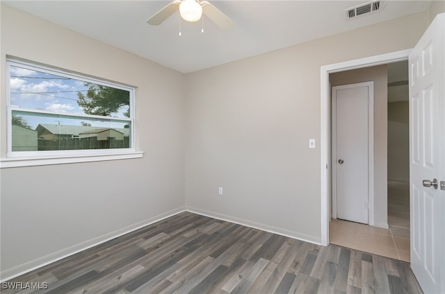 unfurnished room with ceiling fan and dark hardwood / wood-style floors