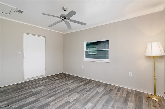 spare room with ceiling fan, dark wood-type flooring, and ornamental molding