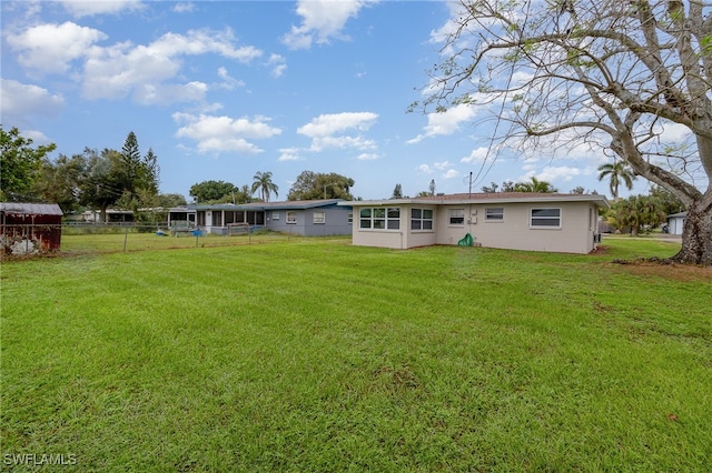 back of property featuring a lawn