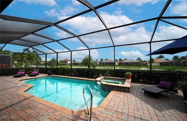 view of pool with glass enclosure, an in ground hot tub, and a patio area