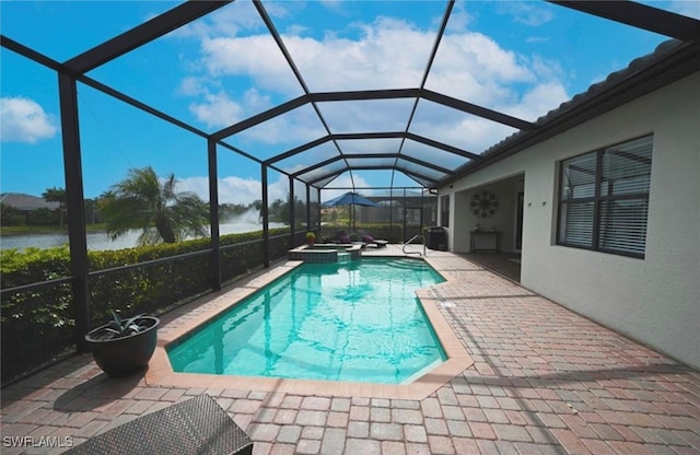 view of swimming pool with glass enclosure, an in ground hot tub, a patio area, and a water view