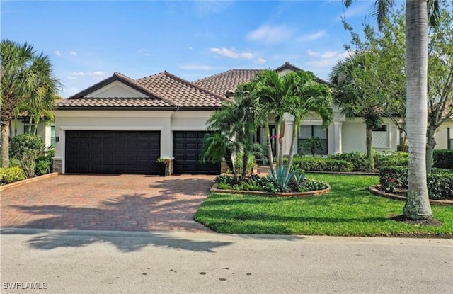 mediterranean / spanish-style home with a garage and a front yard