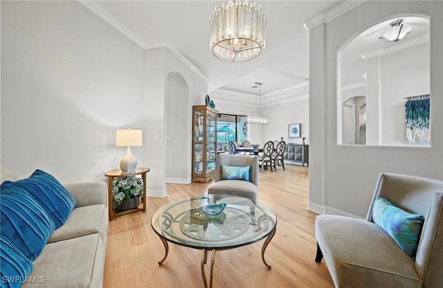 living room with crown molding, an inviting chandelier, and hardwood / wood-style flooring