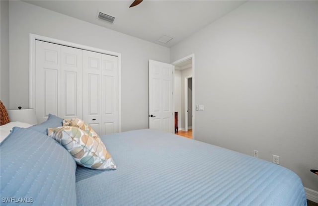 bedroom with ceiling fan and a closet