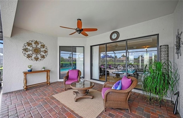 sunroom / solarium featuring ceiling fan