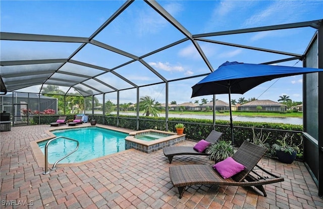 view of swimming pool featuring glass enclosure, an in ground hot tub, a patio area, and a water view