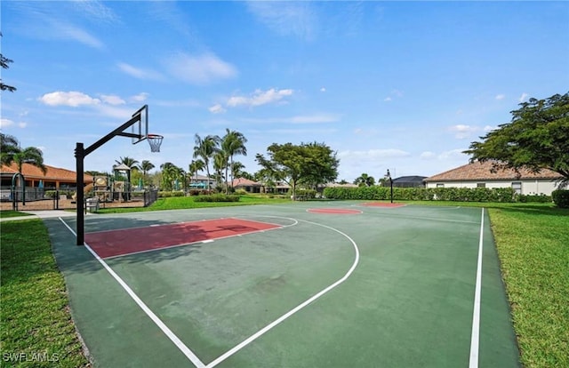 view of sport court with a lawn