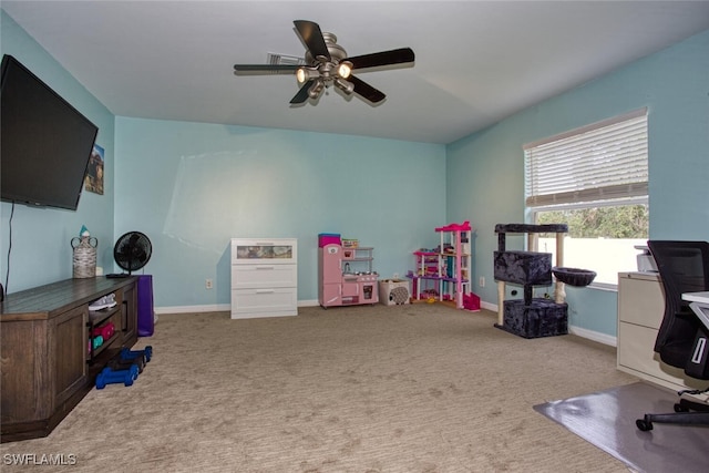 carpeted office space with ceiling fan