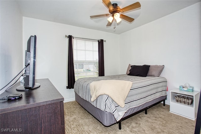 bedroom featuring ceiling fan and light carpet