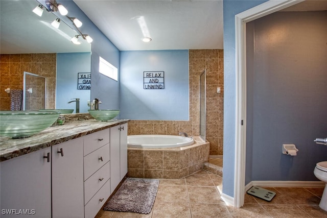 full bathroom with tile patterned flooring, vanity, independent shower and bath, and toilet