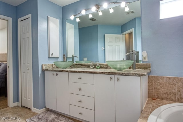 bathroom featuring tile patterned flooring and vanity